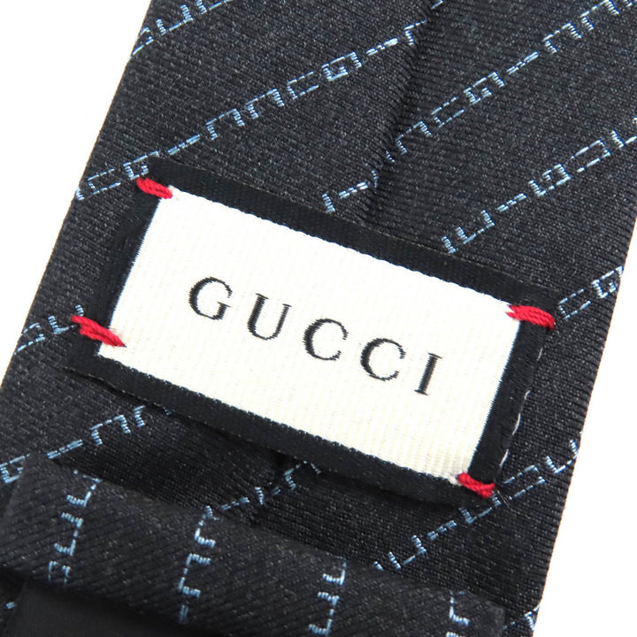 未使用品△GUCCI グッチ ウール100％ レジメンタルロゴストライプ ネクタイ 剣先7CM ダークグレー系 箱付き イタリア製 正規品 メンズ